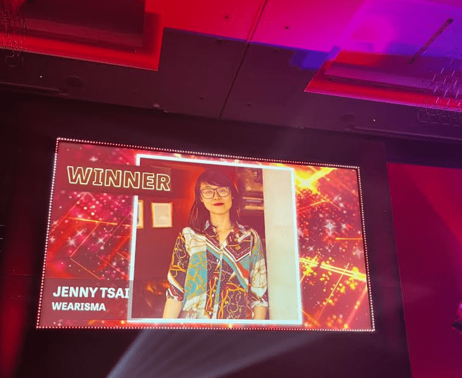 Picture of CEO Jenny Tsai being announced as the winner of the Tech Pioneer of the Year Award on a screen