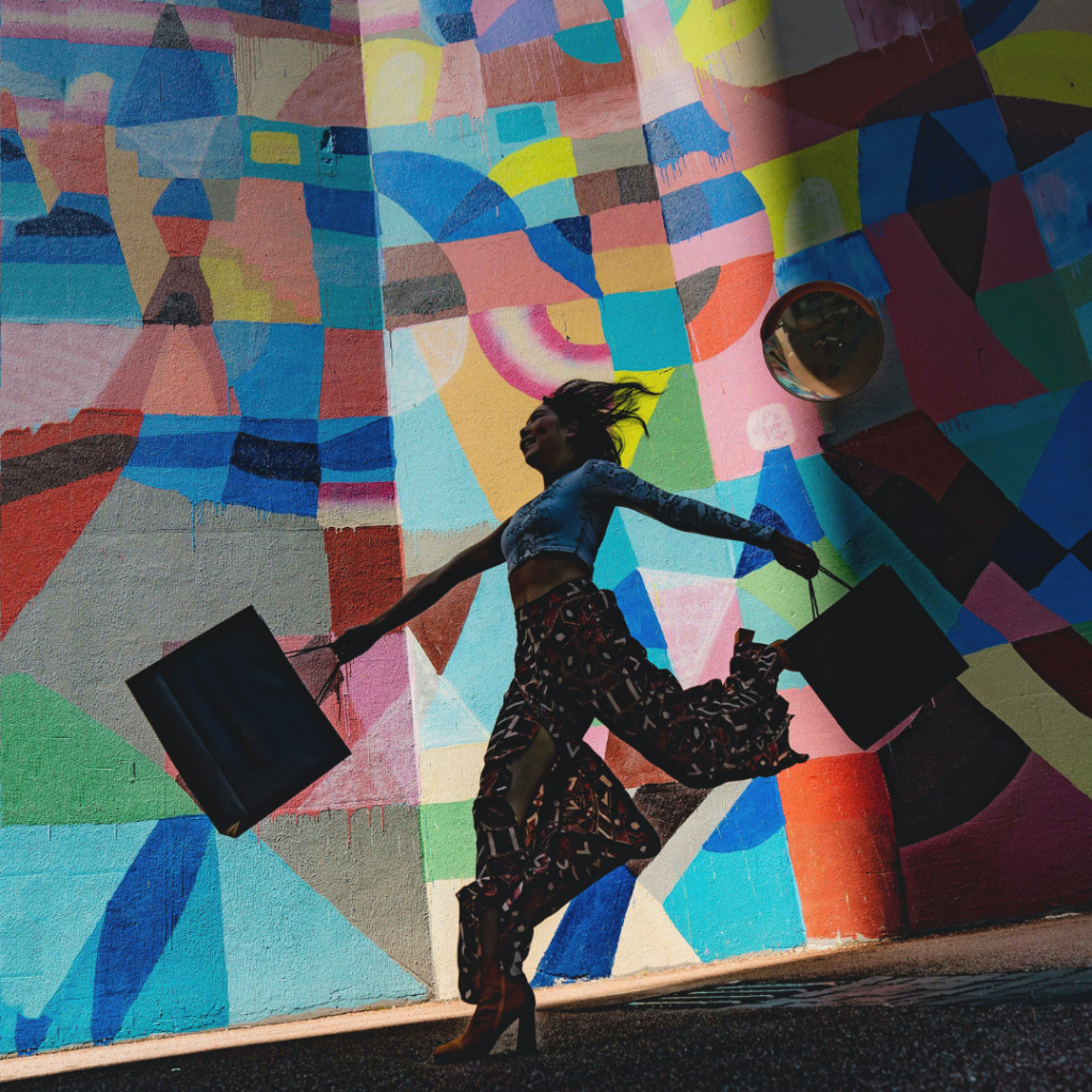 photo of girl with shopping bags and multi coloured background